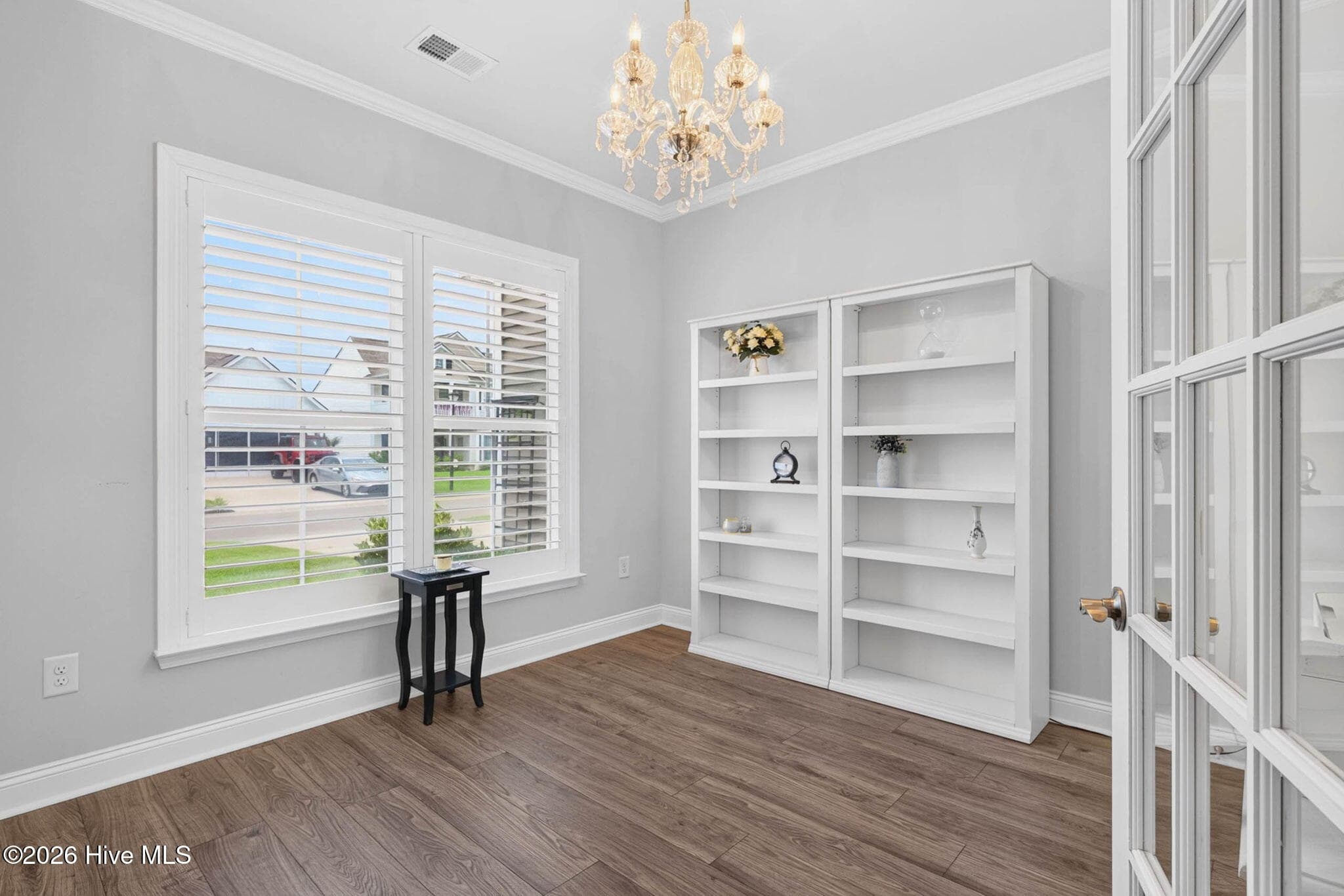 The dedicated home office features French doors, built-in shelving, and abundant natural light for a polished workspace. - 139 Eagle Claw Drive, Calabash, NC 28467