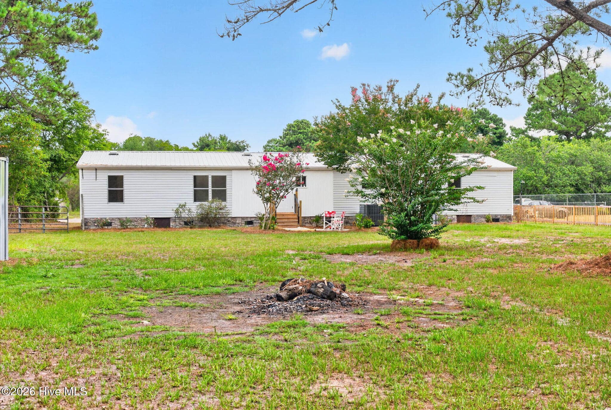 Enjoy the privacy and space of this expansive homesite featuring mature landscaping, a large backyard, and a peaceful setting in Bolivia, NC. - 1199 Zack Street SE, Bolivia, NC 28422