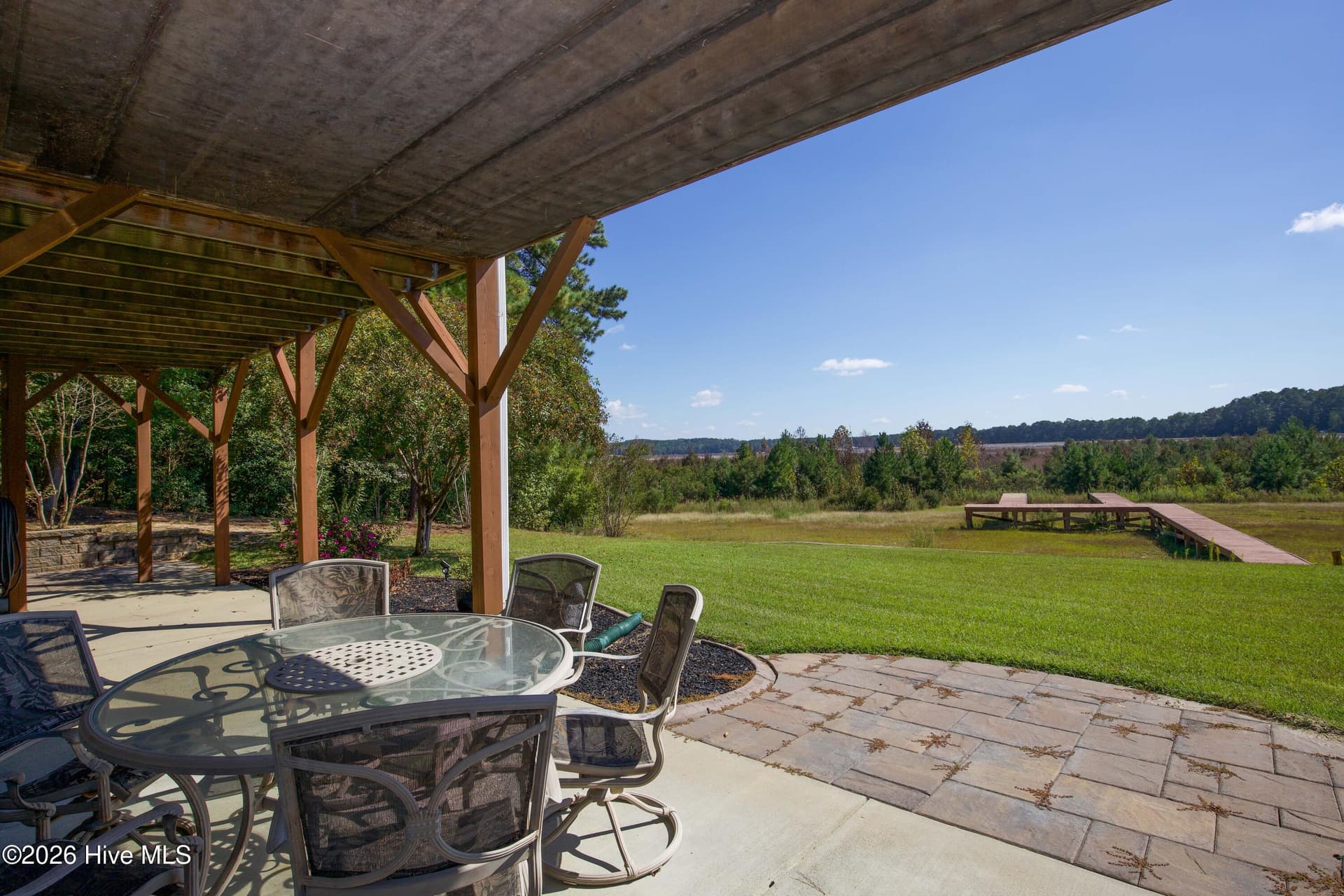 Lower patio and lawn leading toward the existing dock and dry lakebed. - 899 Seagull Drive, Vass, NC 28394