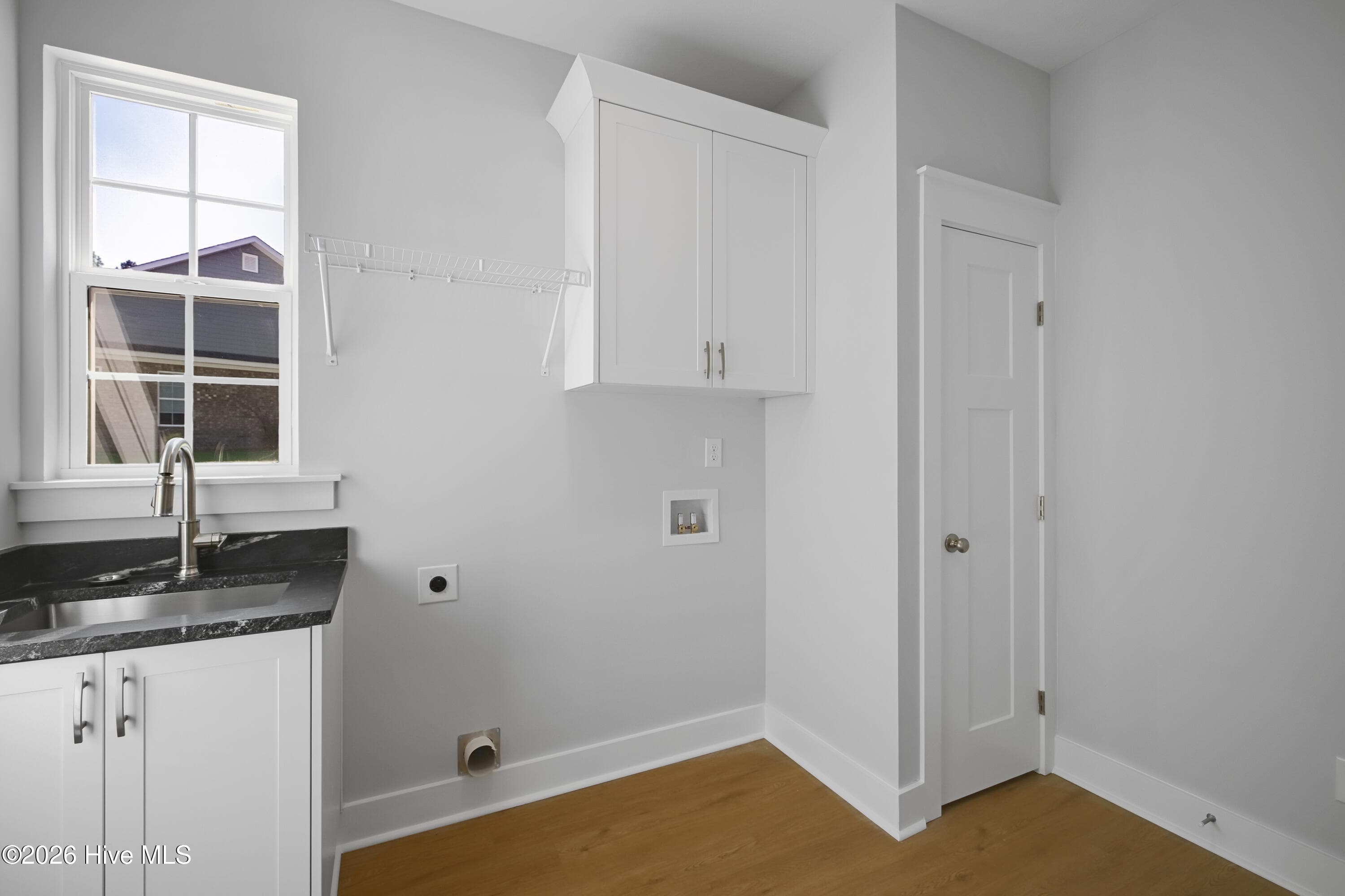 Dedicated laundry room with generous closet space and a utility sink - 458 Longshadow Drive, Aiken, SC 29803