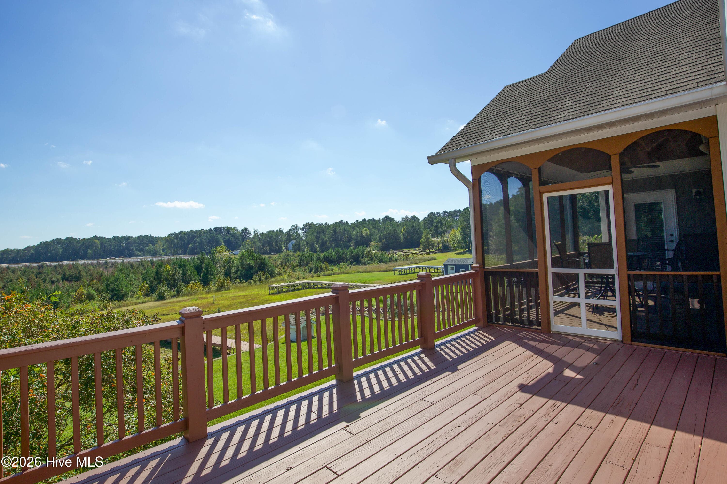 Open deck beside the screened porch, overlooking the lawn, existing dock, and currently dry lakebed. - 899 Seagull Drive, Vass, NC 28394, Vass