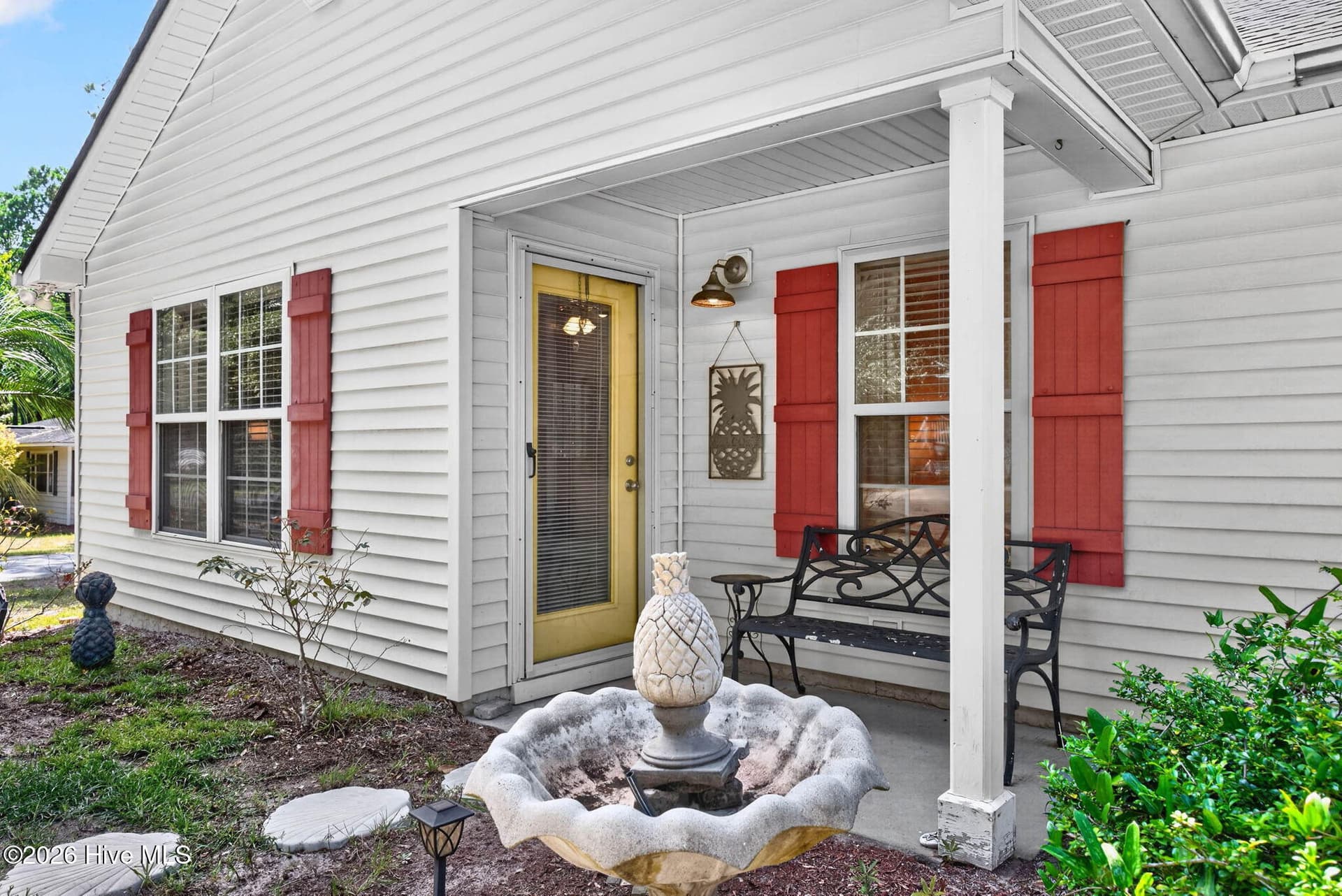 Inviting covered front porch adds coastal charm and a welcoming entrance to the home. - 1650 Frink Street SW, Ocean Isle Beach, NC 28469