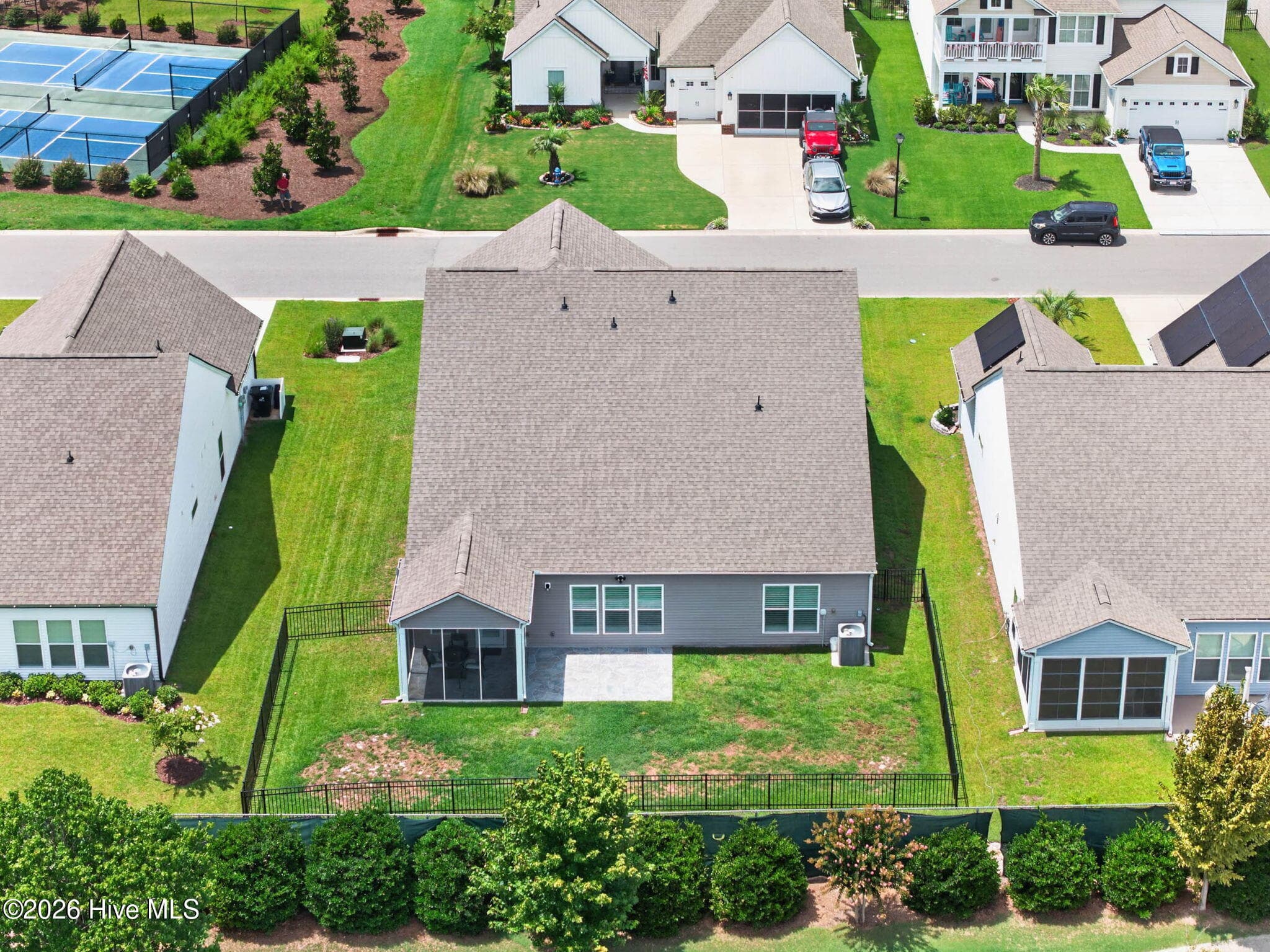 An aerial view highlights the home’s location, fenced backyard, screened porch, and neighboring Eagle Run amenities. - 139 Eagle Claw Drive, Calabash, NC 28467