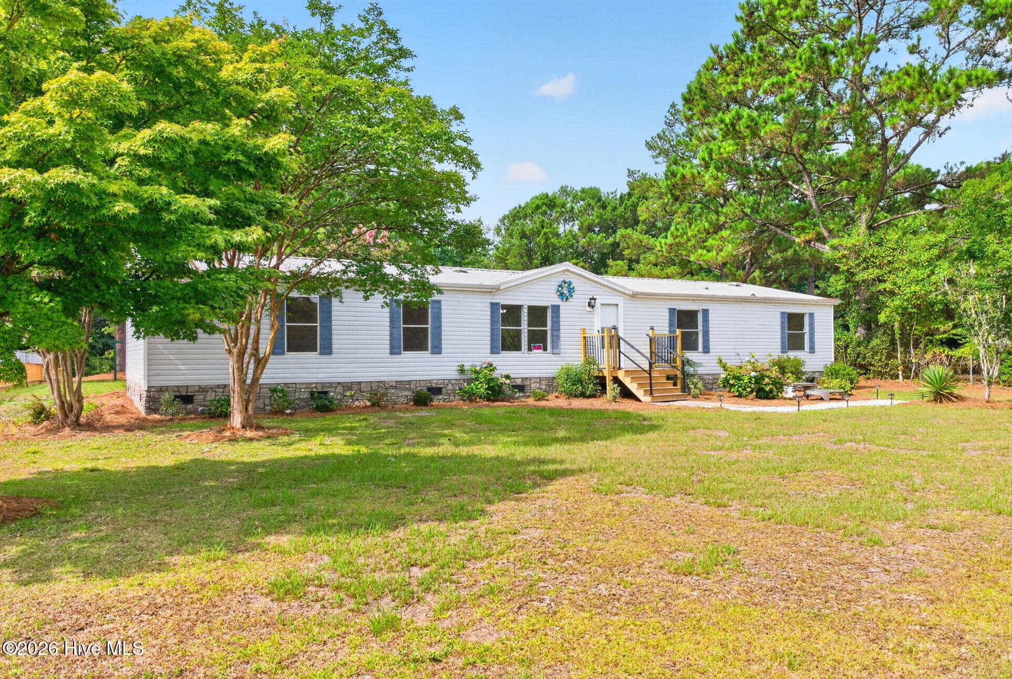 Surrounded by mature landscaping, this move-in-ready home offers a peaceful setting with ample outdoor space to enjoy. - 1199 Zack Street SE, Bolivia, NC 28422