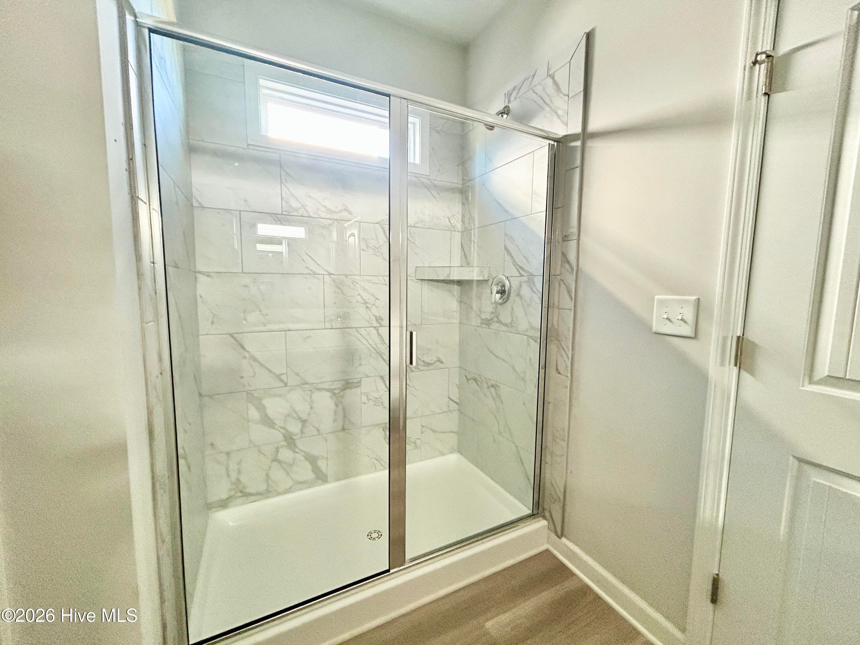 Primary suite features a Private Bathroom with Tile Shower and Large Walk-in Closet - 4208 Workman Loop 94, Leland, NC 28451
