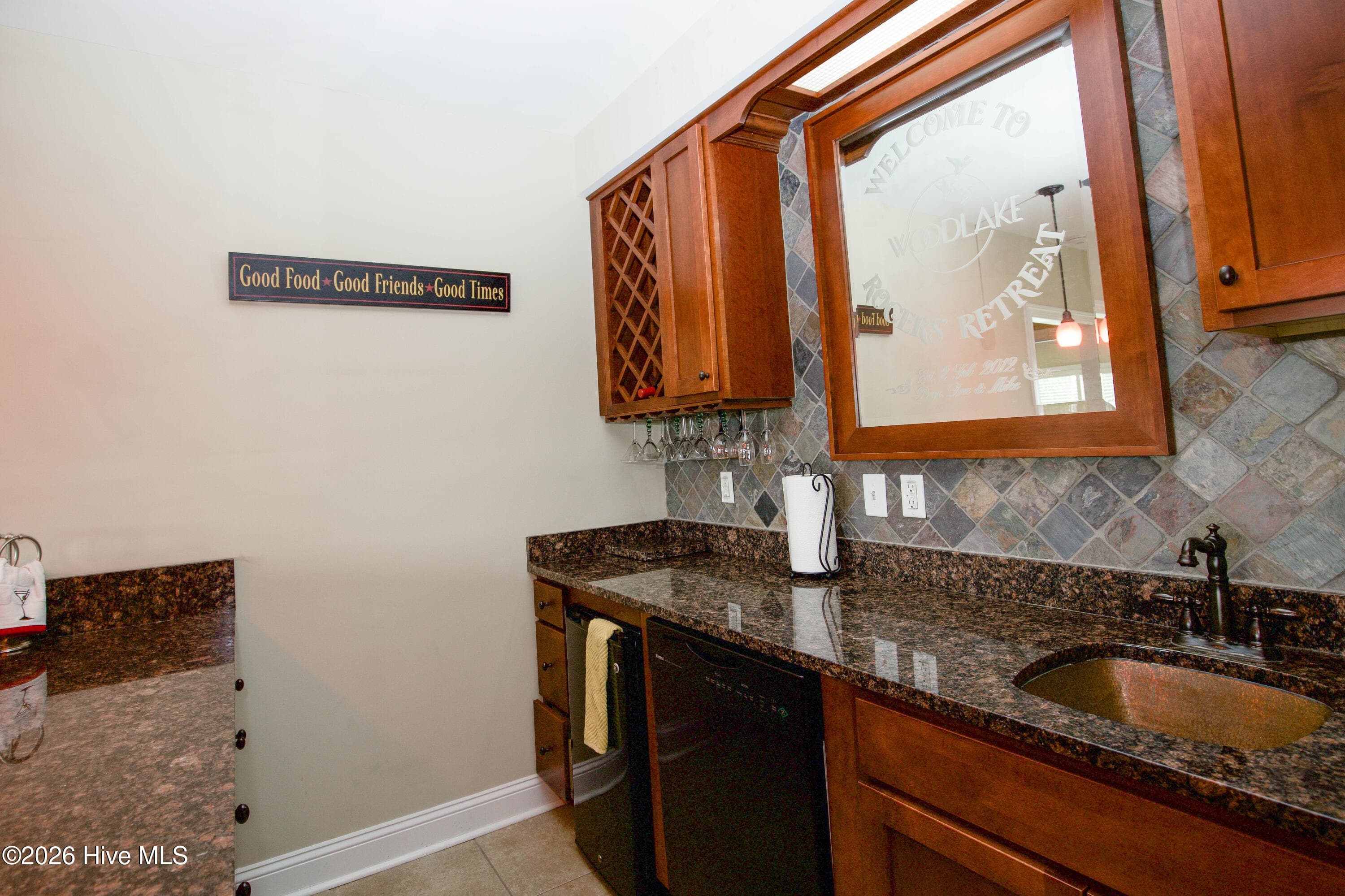 Wet bar with a sink, cabinetry, and wine rack. - 899 Seagull Drive, Vass, NC 28394, Vass