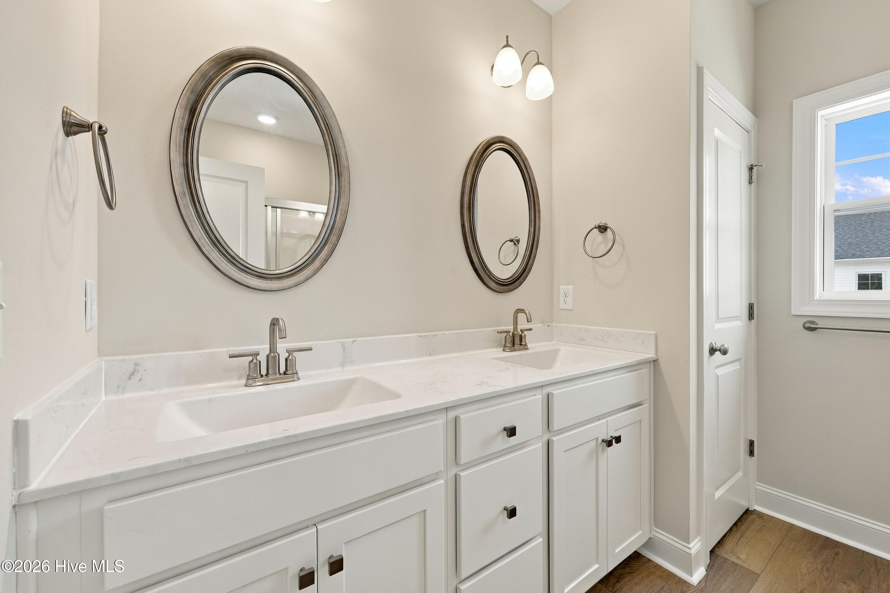 owner bath with dual sink and storage- and a linen closet - 3229 Meadow Drive, Farmville, NC 27828