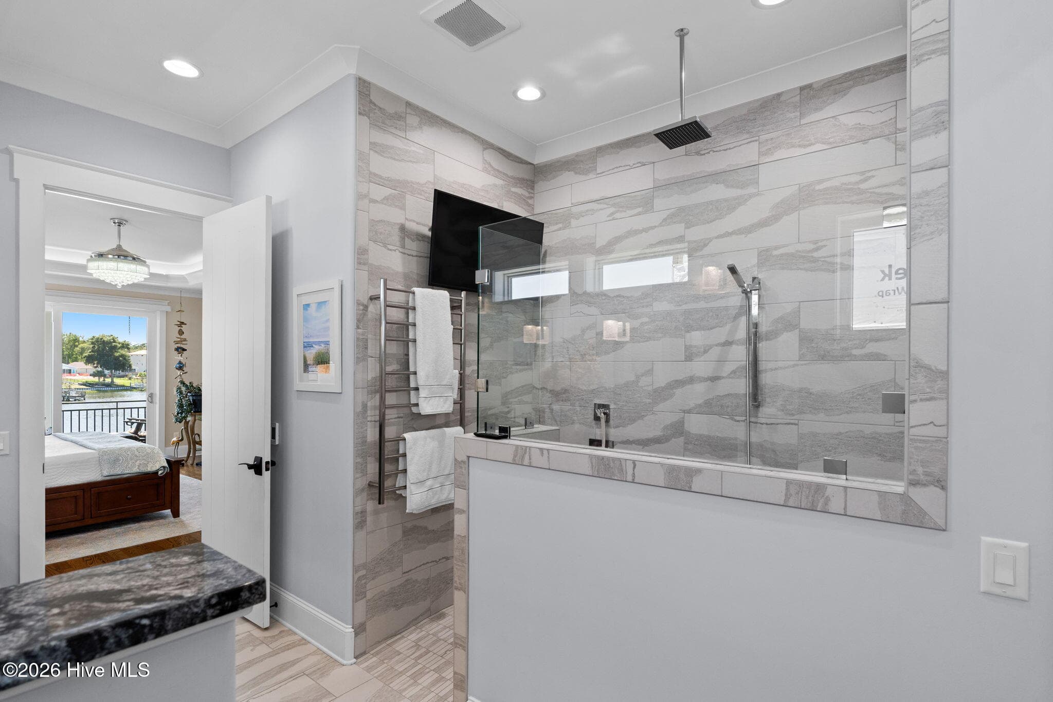 Oversize shower complete with heated towel bars and even a TV to catch the morning news - 2775 Long Bay Drive SE, Southport, NC 28461