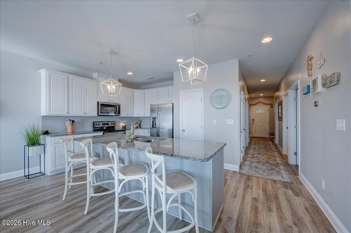 Open plan keeps you connected with good size pantry - 104 Pelican Drive H, Atlantic Beach, NC 28512