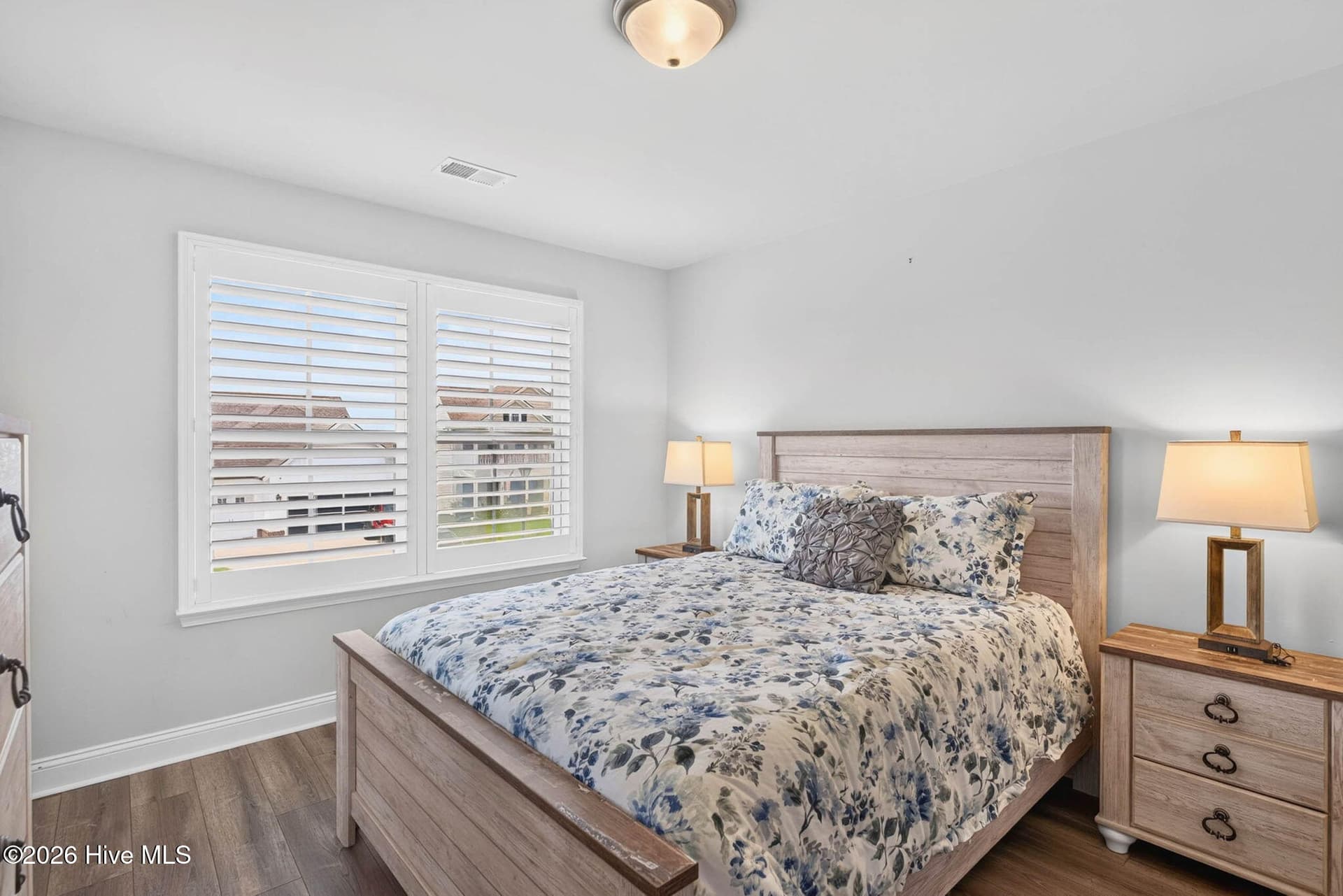 A generously sized secondary bedroom features natural light, a ceiling fan, and space for a complete bedroom suite. - 139 Eagle Claw Drive, Calabash, NC 28467