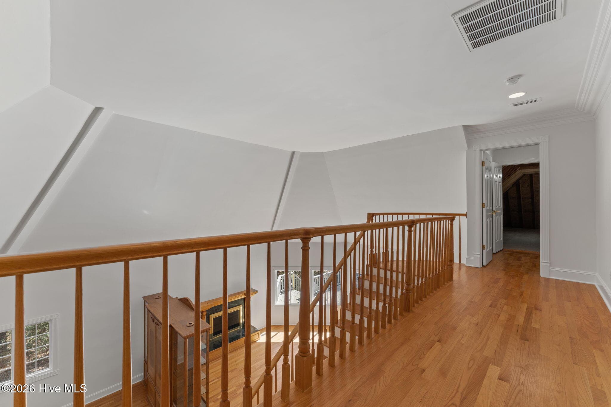 Hallway to the upper bedrooms and open door to walk in floored attic space. - 22 Lochmere Drive, Pinehurst, NC 28374