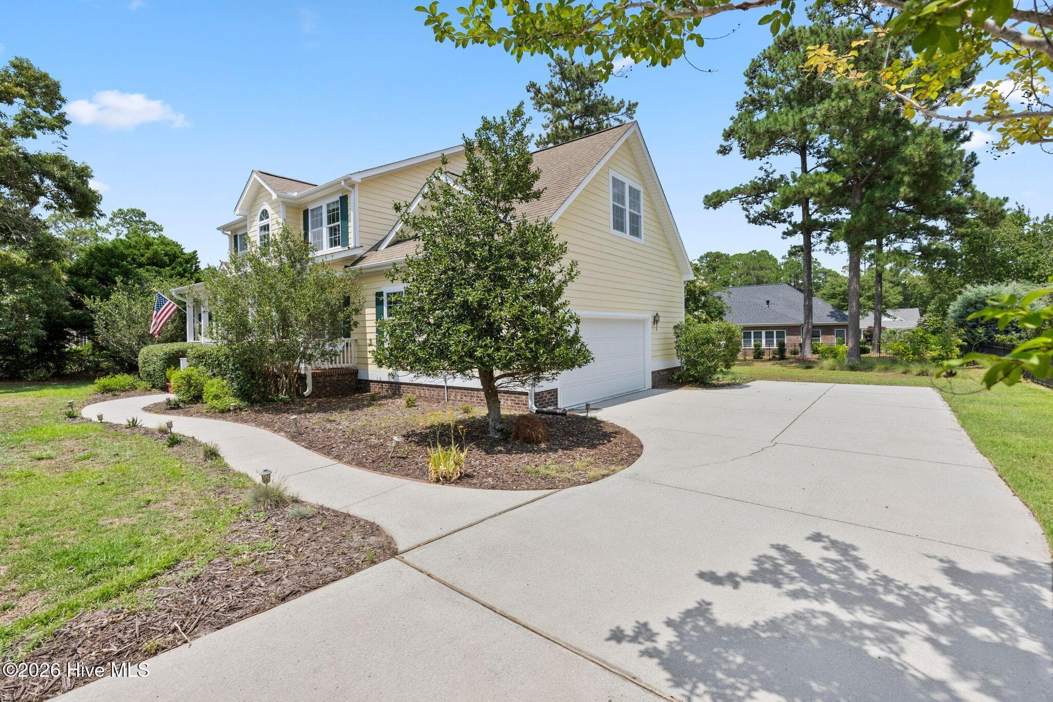 The additional paved parking pad allows plenty of room. - 1620 Golfers Ridge Drive SE, Bolivia, NC 28422