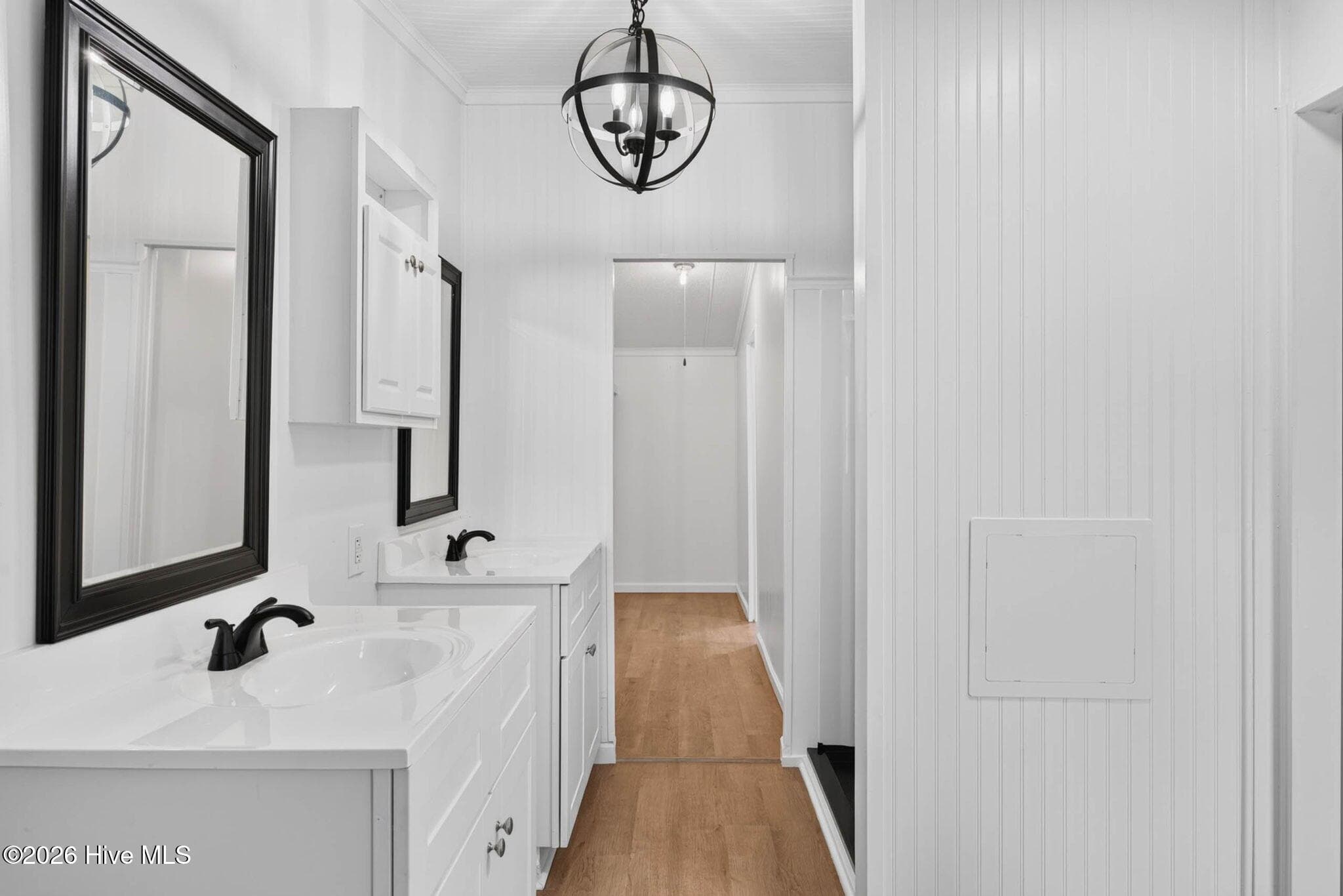 Beautifully updated primary bathroom featuring a modern vanity, stylish fixtures, and a spacious walk-in shower. - 1199 Zack Street SE, Bolivia, NC 28422