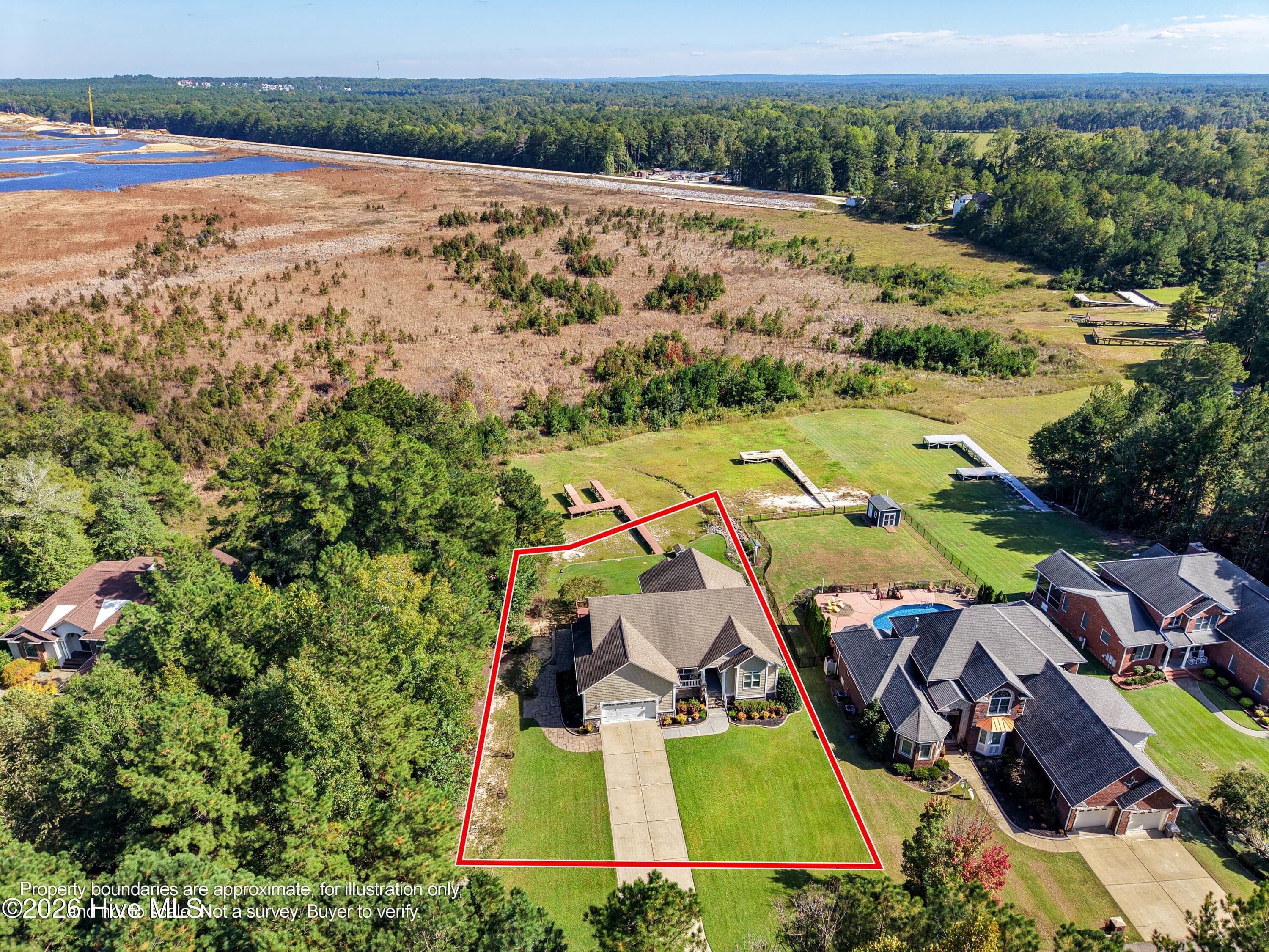 Rear aerial of 899 Seagull Drive, backyard and home. Lot lines approximate, for illustration only, and digitally added; not a survey. Prospective buyers are encouraged to verify property boundries with recorded documents and a current survey as part of thier due diligence - 899 Seagull Drive, Vass, NC 28394, Vass
