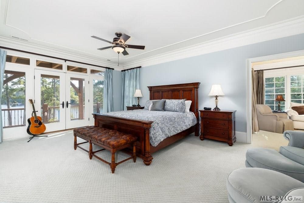 Primary Suite, A spacious traditional bedroom that emphasizes comfort and timeless style, offering a beautiful view of Lake Gaston. - 381 West Bend Dr., Gasburg VA 23857, Gasburg