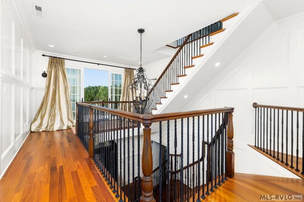 Elegant Upper-Level Hallway and Staircase, This space effortlessly links the private upper-level rooms while maintaining an open view of the floor below. - 381 West Bend Dr., Gasburg VA 23857, Gasburg