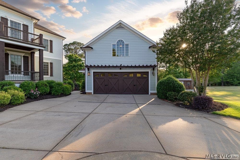 Classic Carriage House Charm, This detached garage captures the timeless charm of a vintage carriage house, offering more than just storage with its pool table, wet bar, and half bath upstairs. - 381 West Bend Dr., Gasburg VA 23857, Gasburg