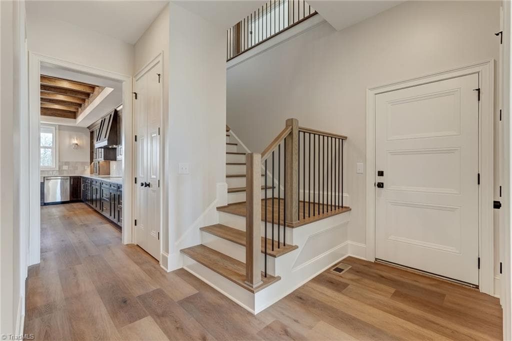Staircase to second level off the garage entry - 7688 Kyran Court, Oak Ridge NC 27310, Oak Ridge