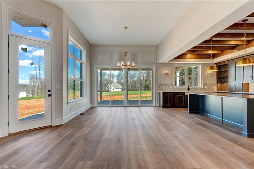 Another view from great room into dining room and out onto porch - porch will feature a Porch Conversions system creating a 4 season space - 7688 Kyran Court, Oak Ridge NC 27310, Oak Ridge