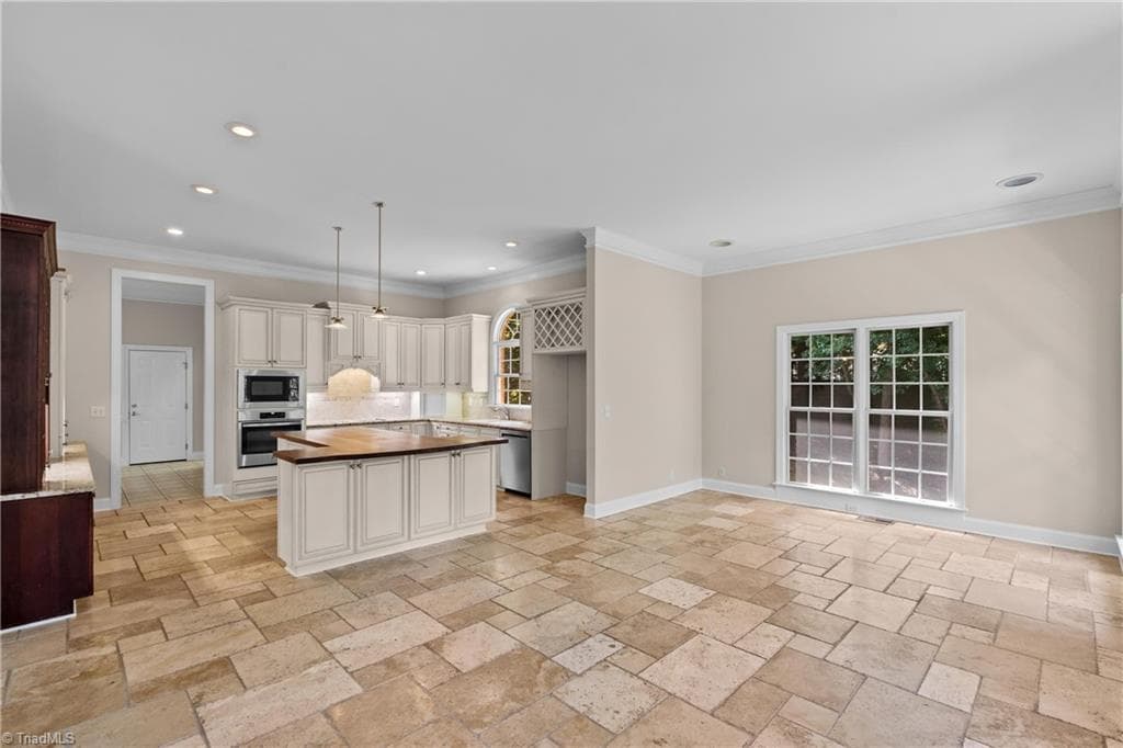 LOOKING FROM THE FIREPLACE INTO THE KITCHEN AND DINING AREA / KEEPING ROOM - 6806 Buckley Drive, Summerfield NC 27358, Summerfield