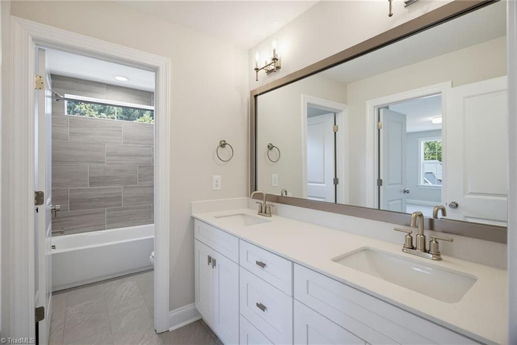 Hall Bath with dual vanity. Separate room for tub/shower and toilet - 4035 Estate Drive, Lewisville NC 27023, Lewisville