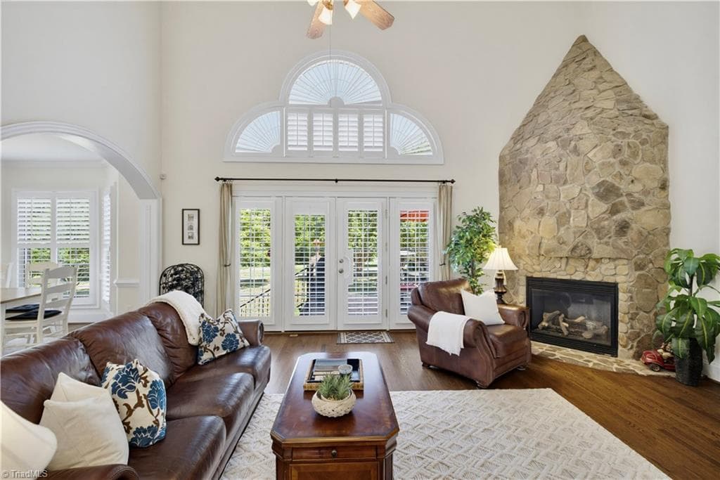 Gorgeous Stone Fireplace featuring gas logs and French doors leading to the double tier patio - 163 Cleek Drive, Summerfield NC 27358, Summerfield
