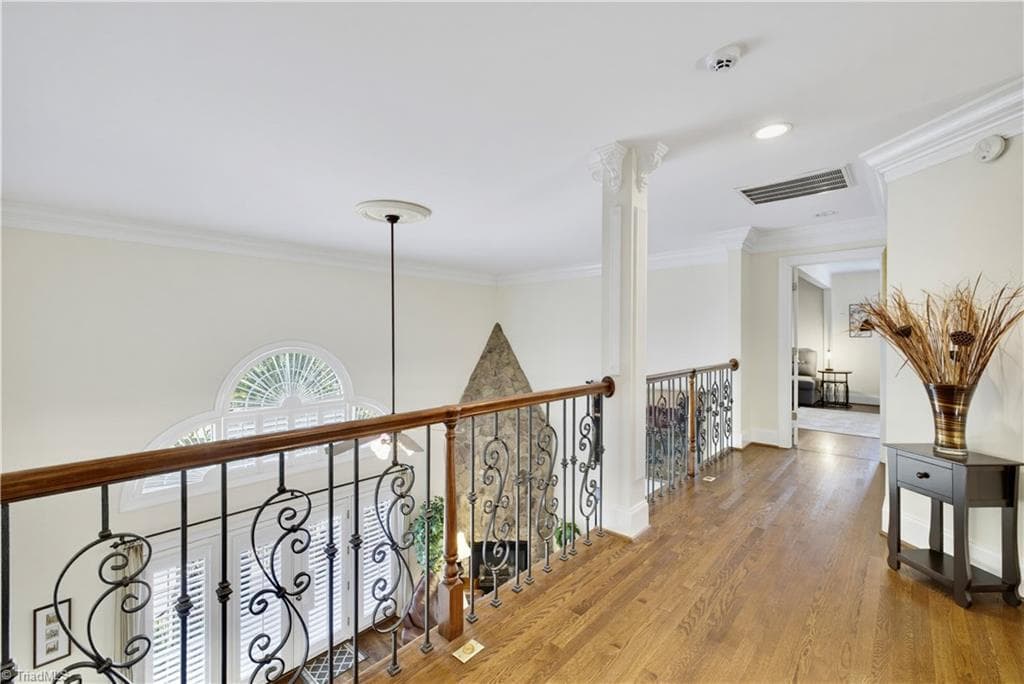 Hallway on second level featuring those beautiful hardwood floors - 163 Cleek Drive, Summerfield NC 27358, Summerfield