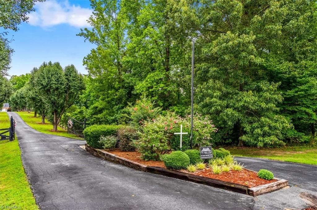 The tree lined drive to the home is adorned with lighting and landscaping that welcomes you as you approach the house. - 6352 Turnpike Road, High Point NC 27263, High Point