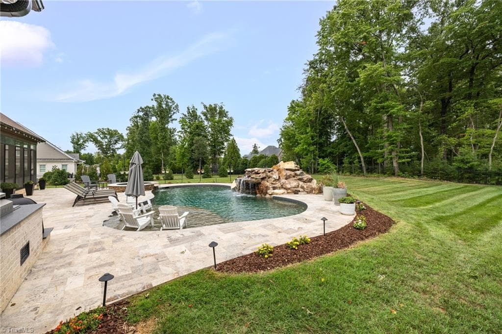Travertine pool decking that stays cooler underfoot and provides excellent slip resistance. - 5503 Briardenn Court, Summerfield NC 27358, Summerfield