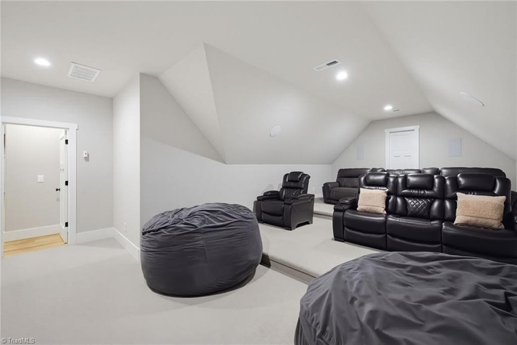 Home theater room with stadium seating and surround sound. - 5503 Briardenn Court, Summerfield NC 27358, Summerfield