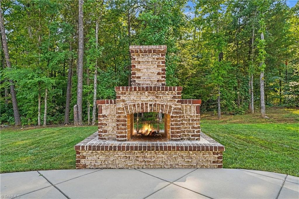 Custom crafted brick fireplace thoughtfully designed to echo the home's exterior details. - 1477 Cappoquin Way, Burlington NC 27215, Burlington