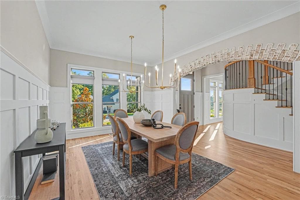 An elegant sun-filled dining room featuring custom woodwork and architectural trim. - 1477 Cappoquin Way, Burlington NC 27215, Burlington