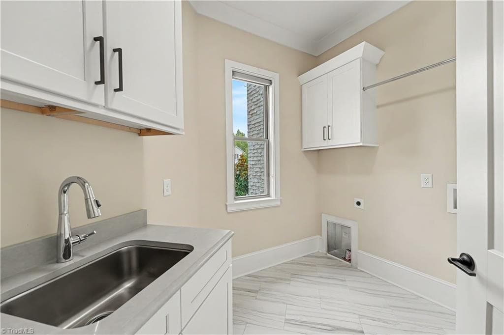 Main-level powder room conveniently located off of the garage entry hallway. - 1477 Cappoquin Way, Burlington NC 27215, Burlington