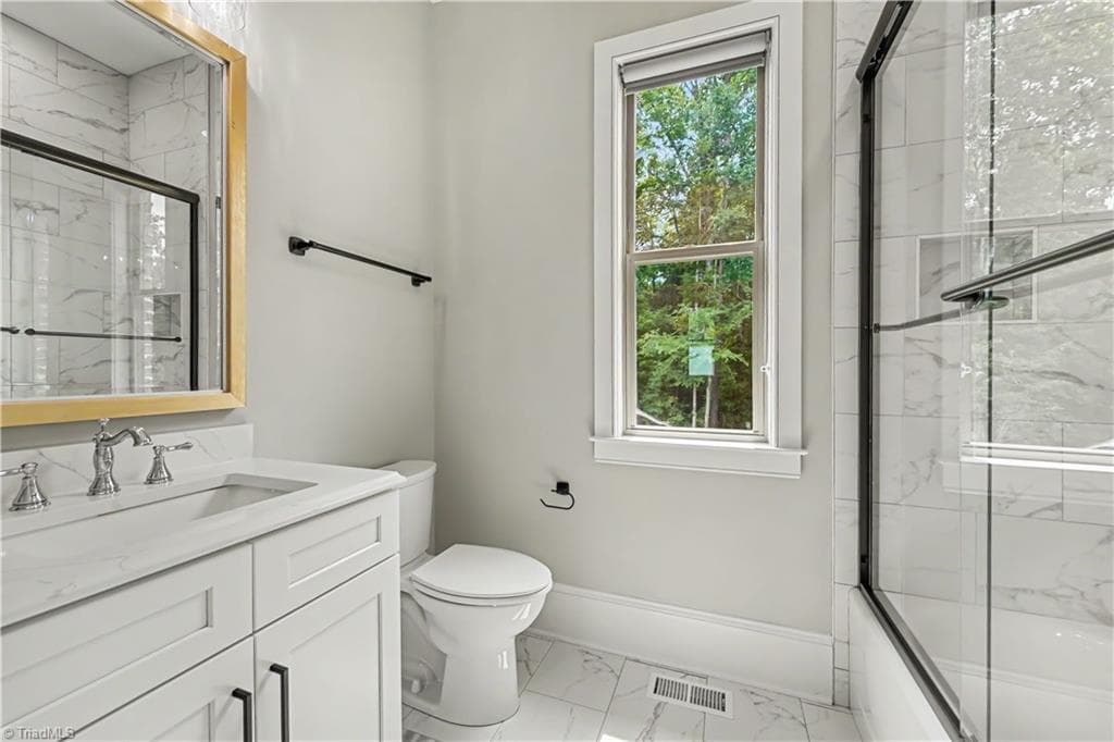 Large upstairs bedroom with ample natural light and spacious closet storage. - 1477 Cappoquin Way, Burlington NC 27215, Burlington