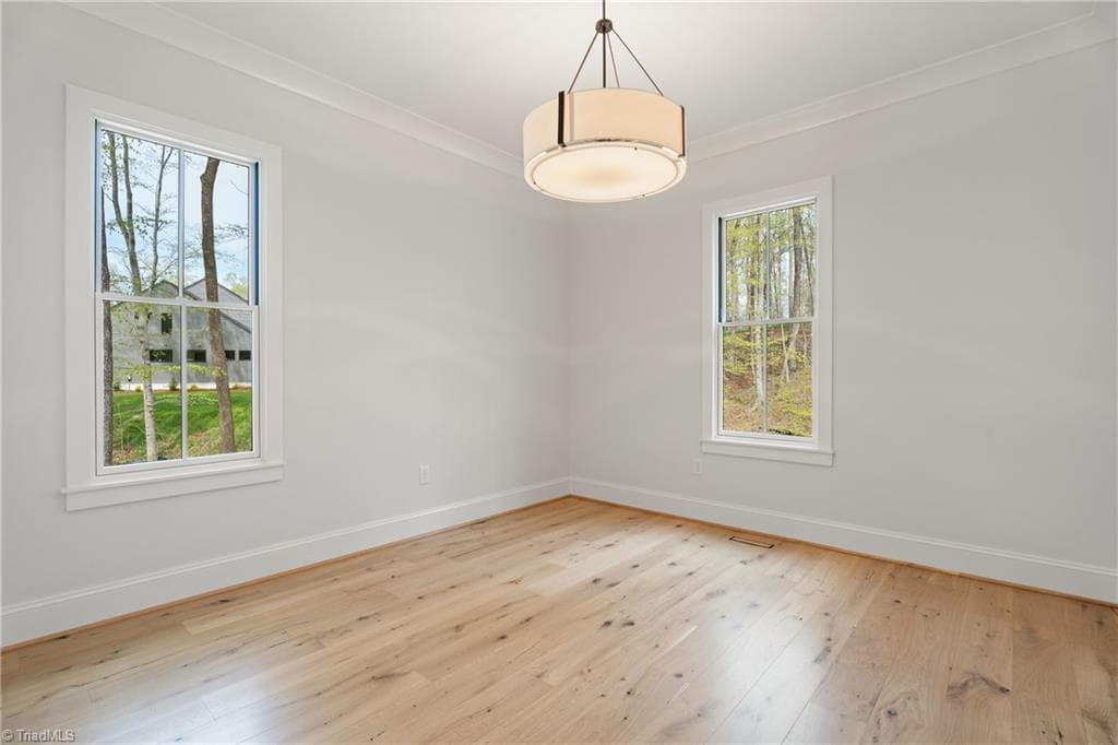 Main level bedroom or office with beautiful natural light and a peaceful setting. - 9664 Lissara Camp Court, Lewisville NC 27023, Lewisville