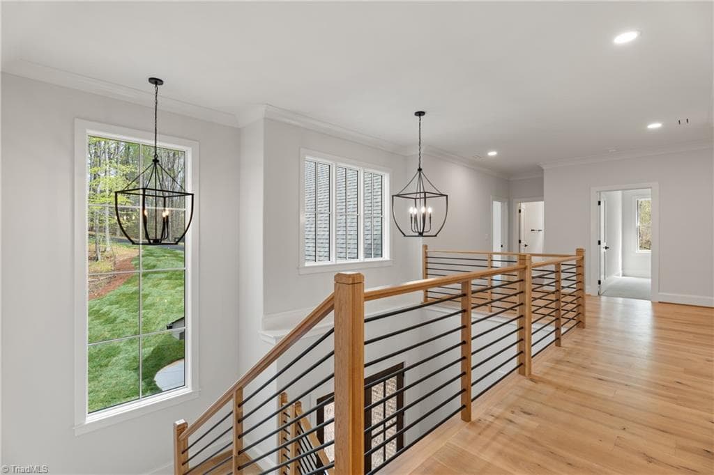 Upstairs loft with open railing, oversized windows, and views overlooking the foyer below. - 9664 Lissara Camp Court, Lewisville NC 27023, Lewisville