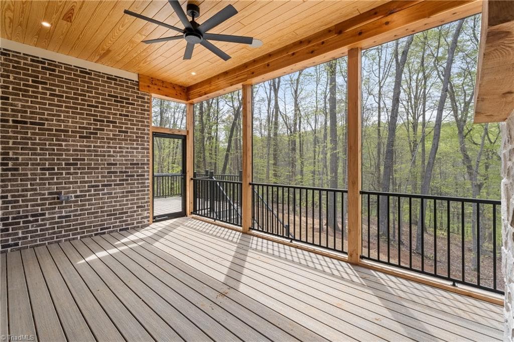 Expansive covered porch designed for year-round enjoyment and peaceful views of the trees. - 9664 Lissara Camp Court, Lewisville NC 27023, Lewisville