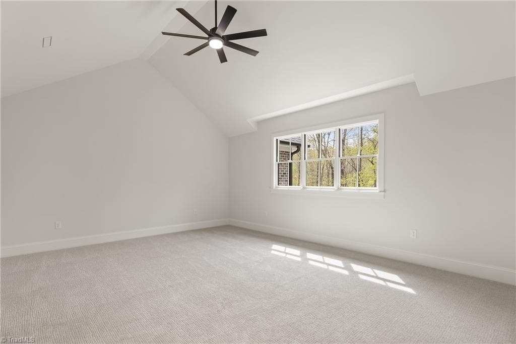 Expansive bonus room with vaulted ceiling, soft natural light, and room to play. - 9664 Lissara Camp Court, Lewisville NC 27023, Lewisville