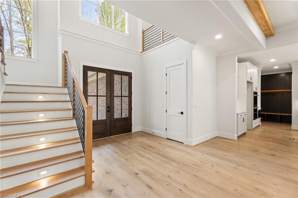 Another view of the foyer showcasing the open staircase and soaring ceiling. - 9664 Lissara Camp Court, Lewisville NC 27023, Lewisville