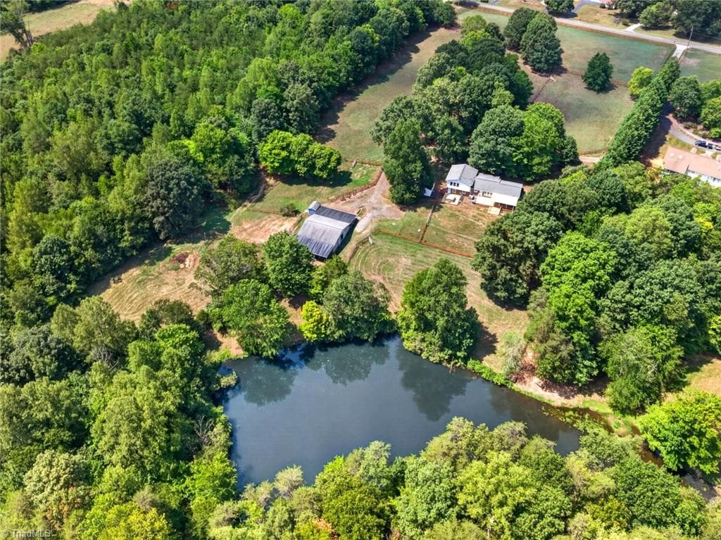 The property is currently setup with 4 pastures but could be expanded to 6. The home features 4 bedrooms with two primary bedrooms (one on the main and one on the upper level). - 8546 Hudson-James Road, Summerfield NC 27358, Summerfield