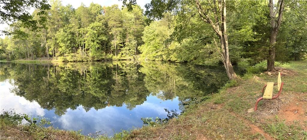 What a great bench to relax by the stocked pond. About 2/3rds of the pond is on your new property. - 8546 Hudson-James Road, Summerfield NC 27358, Summerfield