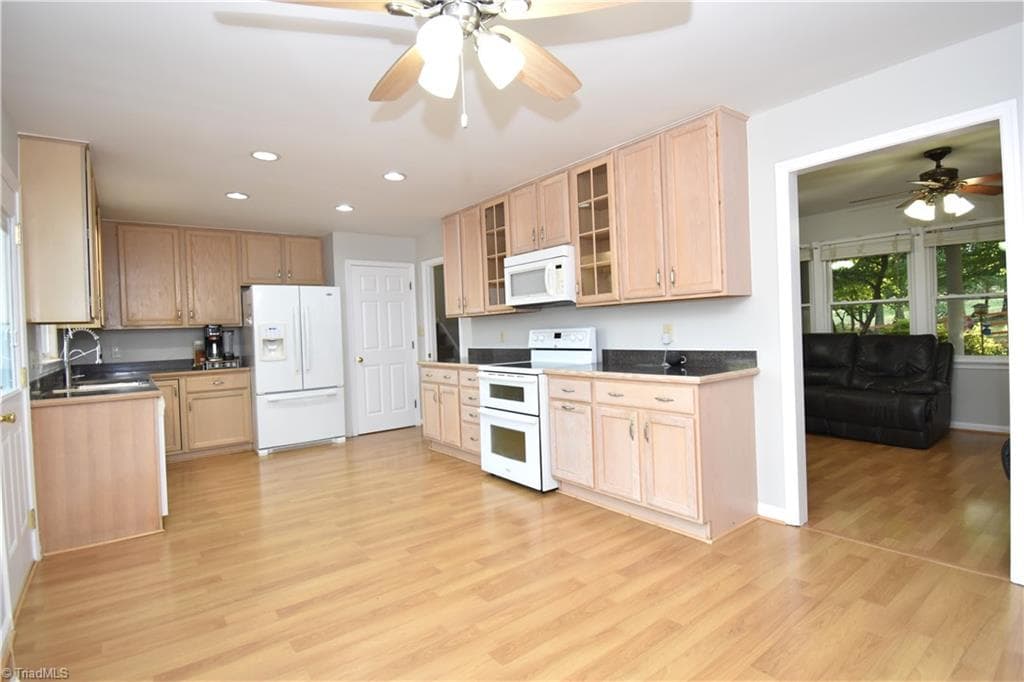 The kitchen features ample storage space and wonderful light. - 8546 Hudson-James Road, Summerfield NC 27358, Summerfield
