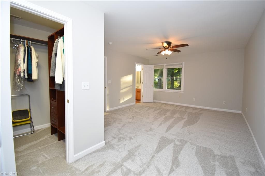 The walk in closet features a built in organizer. This private bedroom features new carpet!!! - 8546 Hudson-James Road, Summerfield NC 27358, Summerfield