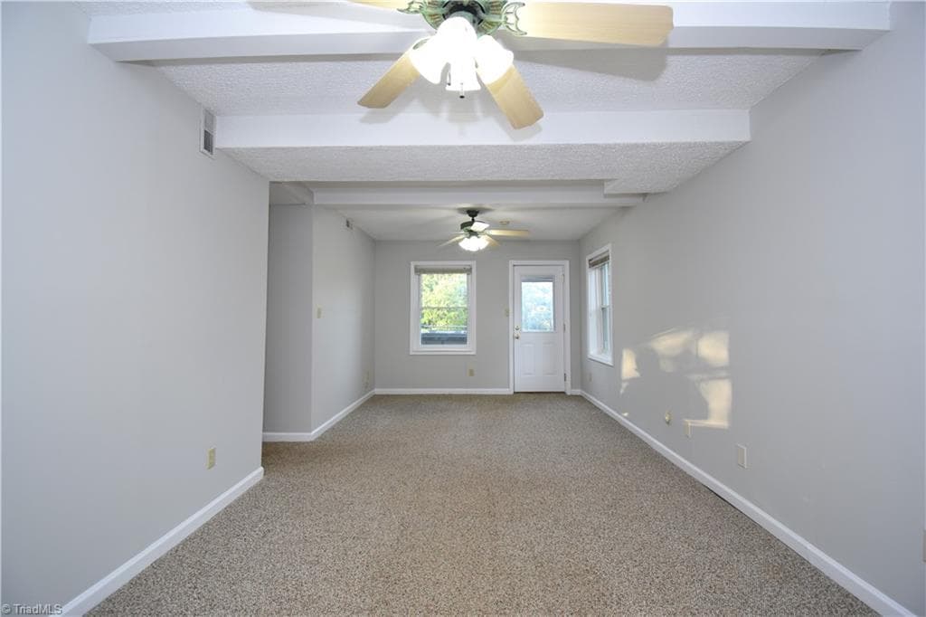 The den features wonderful light and just out the door is the hot tub. - 8546 Hudson-James Road, Summerfield NC 27358, Summerfield