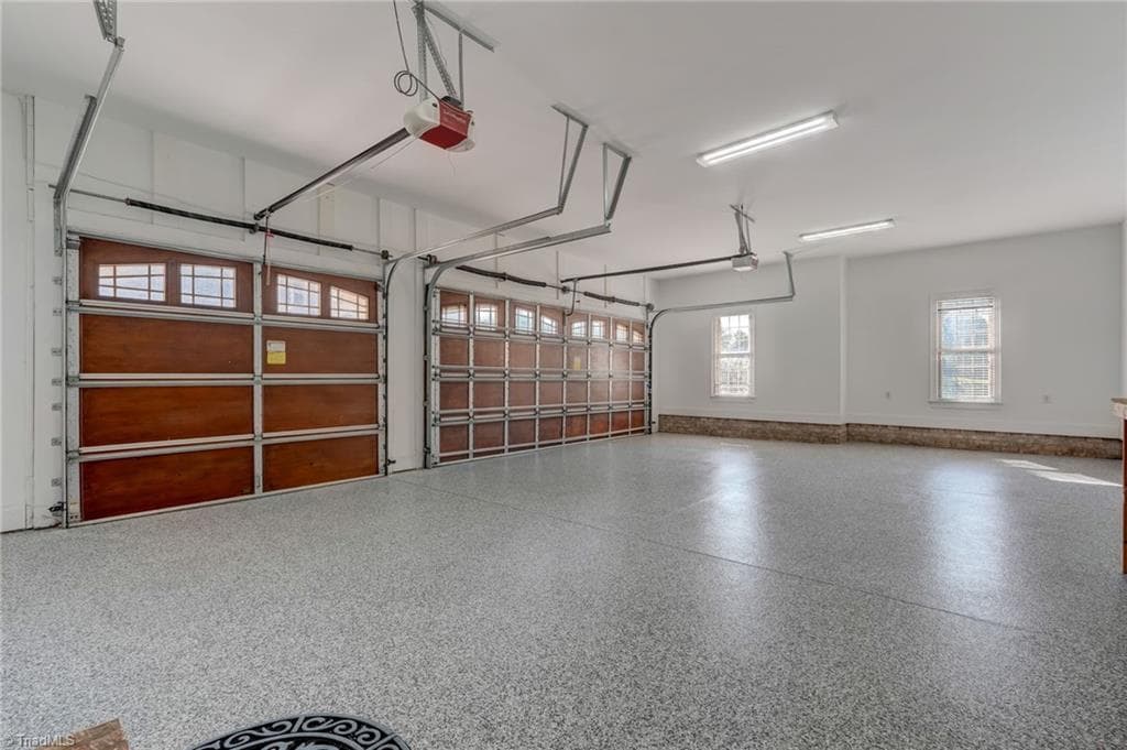 3 car garage with new epoxy flooring and solid wood doors - 4404 Liguria Court, Summerfield NC 27358, Summerfield