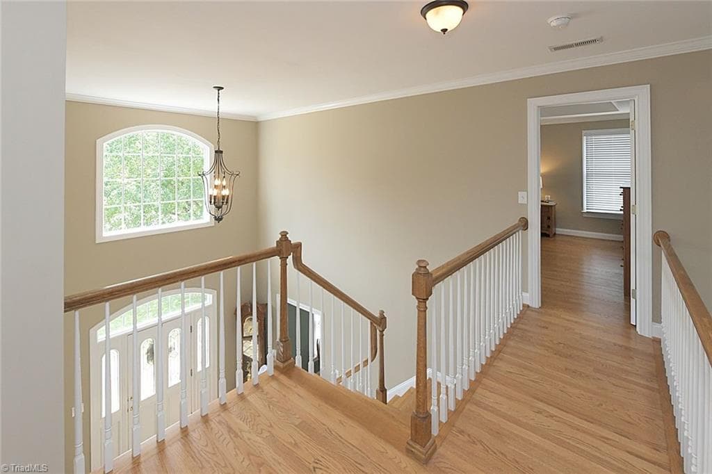 Upper-level landing offering a beautiful view of the home's stunning interior design and architecture. - 1101 Clyde Edgerton Drive, Kernersville NC 27284, Kernersville