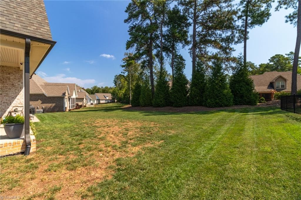 Level back yard with invisible fencing in place for 4 legged family members - 428 Wentworth Drive, Winston-Salem NC 27107, Winston-Salem