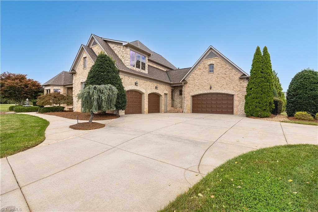 4 car garage gives you plenty of space for vehicles and storage! Pull down attic stairs for additional storage but inside the home has a 3rd floor walk up attic space. - 7404 Hadleigh Court, Oak Ridge NC 27310, Oak Ridge