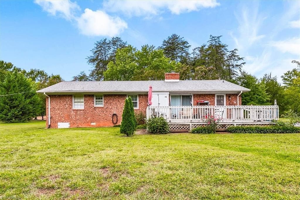 Rear of the 4-bedroom brick ranch with back deck and large yard - 5822 RuralView Road, Gibsonville NC 27249, Gibsonville