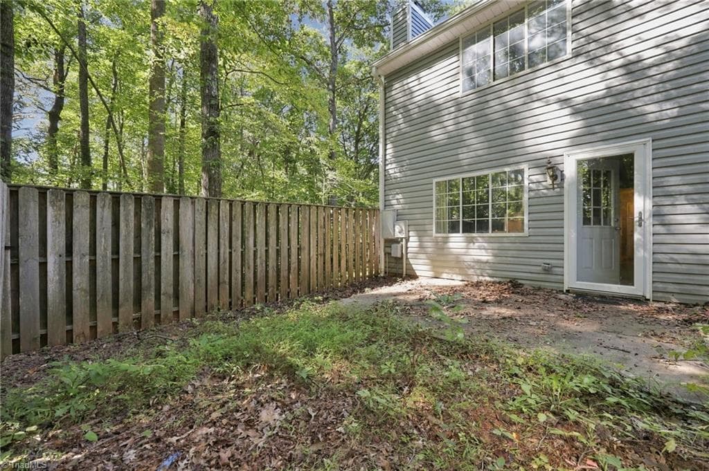 View of the fenced in backyard with patio. - 5500 Richland Street # A, Greensboro NC 27409, Greensboro